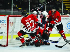 Brockville Braves forward Griffen Molino tangles with Cornwall Colts right winger Kevin Hope in front of the Braves' net as Brockville defenceman Kevin Kirisits guards the left side of the net during CCHL Tier I Jr. A action at the Memorial Centre on Friday night. The Braves won 6-5 in a shootout (STEVE PETTIBONE/The Recorder and Times).