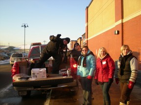 Volunteers help out at the annual Christmas food drive for the Fort McMurray Food Bank. SUPPLIED PHOTO