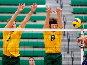 University of Alberta Golden Bears Tristan Aubry, left, and Jay Olmstead defend against Mount Royal University Cougars Jordan Parkin during mens Canada West Volleyball at the Saville centre in Edmonton, Alberta on Saturday, December 1, 2012.