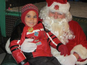 Old St. Nick was about the most popular guy in Wellington Park Saturday night following the official light-up of Panorama. Among those enjoying some face-time with the jolly gift-giver was Evan McDonald of Walsh. (MONTE SONNENBERG Simcoe Reformer)