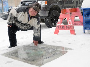 Grande Prairie volunteer Doug Edey officially receives the designation of a Prairie Path Grande Footprint on Saturday in front of CIBC on 100 Avenue. (Adam Jackson/Daily Herald-Tribune)