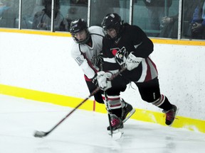 Leandra Timmerman battles for puck position with a defender from the  Wild in the Female Capitals' 5-0 win over Norman on Saturday at the BDO Centre.  (Jordan Maxwell/Portage Daily Graphic/QMI Agency)