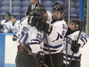 Western Mustangs defenseman Michelle Saunders (5) smiles as she celebrates with her line after they scored a goal against the Queens Golden Gaels during their OUA women's hockey game at Thompson Arena in London on Sunday December 2, 2012.
CRAIG GLOVER The London Free Press / QMI AGENCY