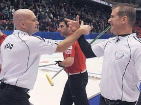 Jeff Stoughton (right) congratulates third Jon Mead after they defeated Glenn Howard 4-3 in the men's final of the Canada Cup in Moose Jaw, Sask., on Sunday, Dec. 2, 2012, and earn a berth to the 2013 Tim Hortons Roar of the Rings Olympic qualifier, next December at the MTS Centre in Winnipeg. Michael Burns/Canadian Curling Association.