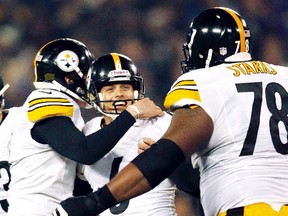 Pittsburgh Steelers kicker Shaun Suisham, centre, of Wallaceburg is congratulated by teammates Drew Butler, left, and Max Starks after kicking a 42-yard field goal with no time left for a 23-20 win Sunday over the Baltimore Ravens on Dec. 2, 2012. (GARY CAMERON/Reuters)