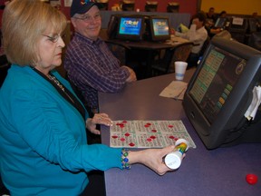 Jackie Poulin mixes the old and the new for Sunday afternoon bingo at the Boardwalk Gaming Centre. 
Jonathan Migneault The Sudbury Star
