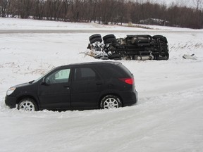 A semi was stuck on its side with another vehicle stuck beside it Monday morning at Bowes Rd. and Highway 1 east of Portage la Prairie. The semi was involved in a rollover and the driver was transported to hospital by ambulance. (ROBIN DUDGEON/THE DAILY GRAPHIC/QMI AGENCY)