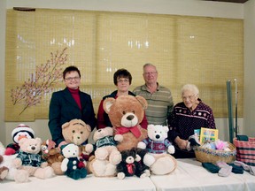 Drayton Valley Cancer Support Group members Eileen Linde, Howard Olsen and Fern Barnay stand with Drayton Valley Health Services Foundation Executive Director Colleen Sekura and just a few of the bears that will be distributed.