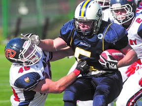 Edmonton Wildcats running back Jordan Samoil straight arms Calgary Colts Matt Pander during football action at Clarke Park this summer. Samoil was named the CJFL’s Rookie of the Year. Photo by Amber Bracken QMI Agency