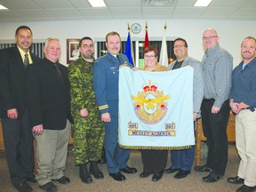 Members of council and the Cold Lake cadet squadron hold the old Medley flag, which will be donated to the museum.