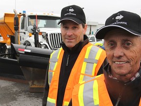 Snowplow operators Steven Peck, left, and Ken Switzer stand in front of one of the big highway rigs following Monday's launch of a new plow safety campaign.
Michael Lea The Whig-Standard