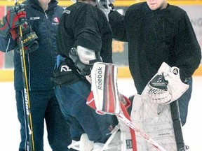 SCOTT WISHART The Beacon Herald
Newly acquired goalie Michael Pesendorfer, at right, chats with fellow netminder Nick Caldwell and goaltending coach Mark Nelson at the Cullitons practice Monday.