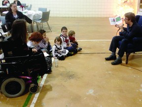 Recorder and Times reporter Ronald Zajac reads to a group of children at the Brockville and District Association for Community Involvement (BDACI) Christmas dinner on Sunday. SUBMITTED PHOTO