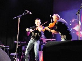 RYAN PAULSEN ryan.paulsen@sunmedia.ca
When Louie Schryer, left, and Brian Hebert go head to head in a fiddle duel, everybody wins - especially the sell-out crowd jammed into Festival Hall on Friday night, Nov. 30, for Songs with Sab, a benefit concert to raise money for Peter "Sab" Sabourin's battle with cancer. For more community photos please visit our website photo gallery at www.thedailyobserver.ca.