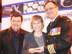 Col. Gerry Blais, director of Casualty Support Management and Joint Personnel Support Unit with the Department of National Defence, presents Ingersoll Machine  and Tool owners Jim and Theresa Hacking with Queen Elizabeth II Diamond Jubilee Medals on Tuesday, Dec. 4, 2012. The medals recognize the Hackings' efforts in supporting wounded Canadian Forces members and their families through the Military Casualty Support Foundation they established in 2006. JOHN TAPLEY/INGERSOLL TIMES/QMI AGENCY