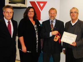Dr. Maartin Bokhout, middle, accepted the Goderich-Huron YMCA Peace Medal last Friday on behalf of his daughter, Jessica Bokhout. Pictured at left is David Yates, YMCA Goderich-Huron Board of Management, Anne Marie Thomson, YMCA Goderich-Huron General Manager and, at right, Jim Jenzan, CEO YMCAs Southwestern Ontario.