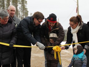 Mayor Michael Lehoux Jane Byers, John Byers, Alan Byers, Nathan Byers, Ashley Byers, Hayden Byers amd Michael Mantha, MPP Algoma-Manitoulin watch on as Arlo Byers cuts the ribbom to officially open Private David Byers Drive on Saturday Dec. 1.  The new road will connect Panache Lake Road and McCulloch Drive near the Light Indurtial Park in Espanola.
Photo by Dawn Lalonde/Mid-North Monitor