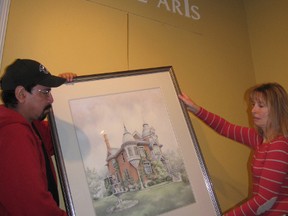 Lawrence House volunteer Dennis Mitchell (left) and lead art educator Hazel Rogers remove a painting from the art centre in Sarnia, Ont. Tuesday, Dec. 4, 2012. The arts centre has closed indefinitely, citing a looming $30,000 debt coupled with a lack of funding. (BARBARA SIMPSON, The Observer)