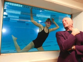 Megan Sherwin, the chairkid for the Variety Village Christmas Fund, shows Mike Strobel the swimming skills she's learned at the Village. (VERONICA HENRI/Toronto Sun)