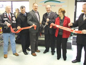 Andrew Bennett - owner of The Algoma Store, and Elliot Lake Mayor Rick Hamilton cut the ribbon to officially open the store. They are accompanied by (left) Councillor Al Collett, chamber of commerce general manager Todd Stencill, (right) Algoma-Manitoulin-Kapuskasing MP Carol Hughes and Algoma-Manitoulin MPP Michael Mantha.	      Photos by KEVIN McSHEFFREY/THE STANDARD/QMI AGENCY