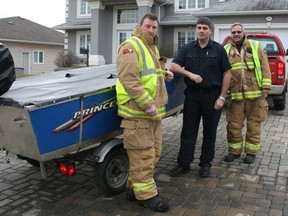 Timmins firefighters Gilles Leduc, from left, Dan Rochon and Lieut. Dennis Sebalj were among those who responded to the rescue of a dog that fell through the ice on the Mattagami River along Bonaventure Drive. The golden retriever was successfully rescued