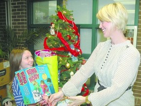 Forest Park Public School Grade 4 student Emma Chilvers delivers her birthday presents Tuesday to learning support teacher Megan Virtue. Chilvers donated all her birthday gifts to the school where they will be passed along to needy families. (Nick Lypaczewski, Times-Journal )