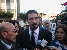 John McAfee, centre, anti-virus software guru, attends a news conference with his lawyer Telesforo Guerra, left, outside of the Supreme Court of Justice in Guatemala City, December 4, 2012. (REUTERS/William Gularte)