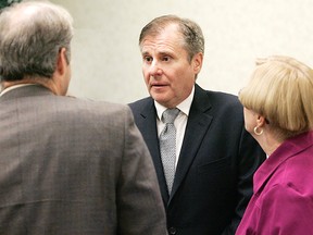 Phil Gillies talks with Greg Martin and Karen George at an Ontario Progressive Conservative nomination meeting late last year (Expositor File Photo)