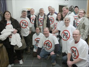People opposed to the public-private partnership model for the new 270-bed Providence Care Hospital in Kingston gathered for a group photo before going into Tuesday night’s meeting of city council at Canadian Forces Base Kingston.