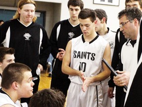 St. Basil Saints head coach Lou Mazzuca (right) has a chat with his players prior to Tuesday’s season opener against the Korah Colts.