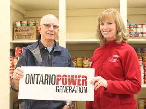 Winston Mick, a 10-year volunteer with the St. Joseph’s Food Bank (left) accepts a $500 donation from the Ontario Power Generation presented by Jennifer Gardiner. The money will help provide people with food items for the holidays. For more community photos please visit our website at www.thedailyobserver.com.