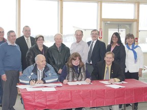 Erin Steele/R-G
The Village of Nampa, Northern Sunrise County and Town of Peace River signed a historic partnership agreement in the Peace Regional Waste Management Company (PRWMC) last week. At the table are (left to right) Nampa Mayor Klaus Noruschat, County Reeve Carolyn Kolebaba and Mayor Lorne Mann. Above, left to right is Peace River councillor and PRWMC Chair Geoff Milligan, Vice-Chair and NSC Councillor Evens Lavoie, Peace River MLA Frank Oberle, NSC Councillor Marie Dyck, Village of Nampa Councillor and board member Ed Skrlik, County councillor and board member Doug Dallyn, Town of Peace River Councillor and board member Tom Tarpey, County councillor and board member Darlene Cardinal and Pearl Calahasen, Lesser Slave Lake MLA.