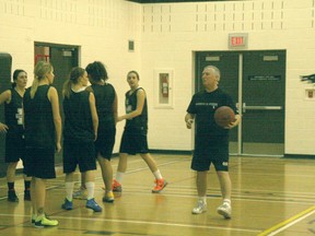Joe McLaughlin, right, goes over a drill with the George McDougall Mustangs senior girls’ basketball team.
CHRIS SIMNETT/AIRDRIE ECHO