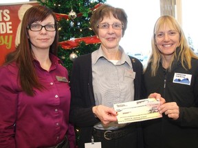 The Shoppers Drug Mart 2012 Tree of Life fundraiser harvested more than $3,513 for the Cochrane and Area Victim Services Society. The donation was presented on Monday by, from left, Leithe Holowaty, pharmacist/owner, and Joan Joe, Tree of Life captain, to Laurie MacKenzie, executive director of Cochrane and Area Victim Services.
