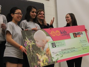 Harman Khinda, centre left, the vice-president of McNally’s student union, presents the Kids with Cancer Society with a cheque for $41,000, part of what was raised by the students at the school’s annual Bike-a-thon on Nov. 29-30. DALE BOYD Special to the Examiner