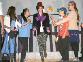 Violet Beauregard, Mrs. Beauregard, Mike Teevee and Ms. Teevee are star-struck when Willy Wonka makes his debut during St. Joseph's Catholic School's performance of Willy Wonka Junior Wednesday December 5. In character from left to right are students: Rachel Bohnert, Hannah Reich, Linneah Reynolds, Hunter Cannon and Ashley Schlorff.