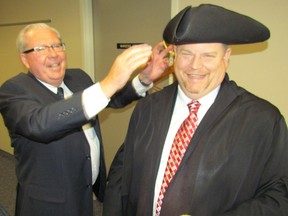 Newly-elected Warden Todd Case dons the traditional garb Wednesday, minutes after his election in Wyoming. Case, who is mayor of Warwick Township, became Lambton County's 155th warden after a secret vote among county councillors. Petrolia Mayor John McCharles also ran for warden and assists Case with the tricorn hat.  CATHY DOBSON/THE OBSERVER/QMI AGENCY