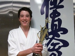 Tyler Pesci has a tight hold on the trophy he won for championing the 15-16-year-old division of the Vancouver Cup knockdown karate tournament on Sunday, Dec. 2, 2012. Russ Ullyot/ Banff Crag & Canyon/ QMI Agency