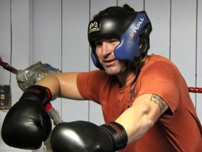 Boxer Steve Wyville, 43, rests on the ropes after sparring at the River City Boxing Club Monday, Dec. 3, 2012 in Sarnia, Ont. (PAUL OWEN/THE OBSERVER/QMI AGENCY)