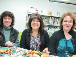 Town staff, from left, Karen St. Martin, chief administrative officer, Candi Graumann, municipal secretary, and Melody Golden, tax/utilities clerk, have lunch with the Mayerthorpe Genealogy group (also known as the GENIES) on Wednesday, Dec. 5, at the Mayerthorpe Public Library. The annual potluck event is held at the library and the group invite town staff to join them as a thank you for their hard work through the year. The GENIES have been meeting at the library for 14 years.