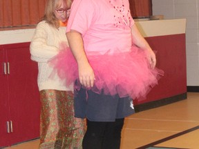 Cayley School librarin Colleen Jantzen helps Grade 7/8 teacher Aaron Langstraat put on a bright pink tutu on Dec. 5, 2012.