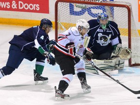 Owen Sound Attack forward Daniel Catenacci tries to put the puck past Plymouth Whalers defenceman Nick Malysa for a shot on Whalers goalie Matt Mahalak during first period Ontario Hockey League action between the Attack and Whalers at the Harry Lumley Bayshore Community Centre on Wednesday night.