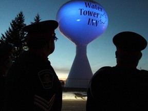Sault Ste. Marie  Police Service Sgt. Ray Magnan, left,  and Const. Fred Brown admire the blue light shining on the water tower on Wednesday. The Algoma Water Tower Inn & Suites illuminated the tower for the second year as part of project blue light. Project blue light recognizes police officers who have been killed in the line of duty. The water tower will remain blue for the rest of the year.