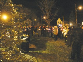 Crowds gather Wednesday evening during the lighting ceremony of the Loving Memory Tree, located at the Memory Garden on Mary Street. Sponsored by the Bereaved Families Ontario-Pembroke, the tree and the candles are symbols which people look to during the holiday season to quietly remember loved ones.