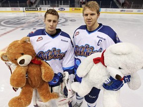 Edmonton Oil Kings' Laurent Brossoit and Griffin Reinhart pose for a photo during a press conference to show off the hockey jerseys the  team will wear during the 6th annual Teddy Bear Toss game, in Rexall Place in Edmonton, Alta. on Monday December 3, 2012. The game will be held December 7th against the Calgary Hitmen.