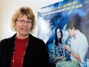 Lori Blight at the Portage and District Arts Centre stand next to a poster for Salmon Fishing in the Yemen. Blight has officially received the executive director's position at PDAC after serving as acting director for the past six months. (Svjetlana Mlinarevic/Portage Daily Graphic/QMI Agency)