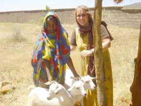 Kathy Andersen presenting goats to a woman in southern Ethiopia. (Supplied)