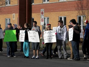 Students at Queen Elizabeth Collegiate Vocational Institute demonstrate in front of the Kirkpatrick Street high school Thursday in support of teachers. As soon as Dec. 10, the students fear teachers will stop supervising and participating in extra-curricular activites in protest of Bill 115. (Danielle VandenBrink/The Whig-Standard)