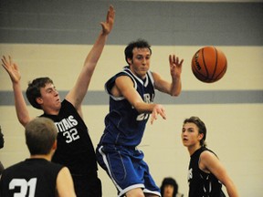 Simcoe centre Kevin Allemang passes out against double coverage during Thursday's season opening game against the Holy Trinity Titans. SCS won the close contest 33-30. (SARAH DOKTOR Simcoe Reformer)