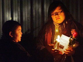 Amanda White lights a candle for her nephew Grant Hill at the Woodland Cultural Centre. Brantford Native Housing in partnership with the Sexual Assault Centre of Brant held a candlelight vigil on Thursday night to mark the National Day of Remembrance and Action on Violence Against Women. - CHRISTOPHER SMITH, The Expositor
